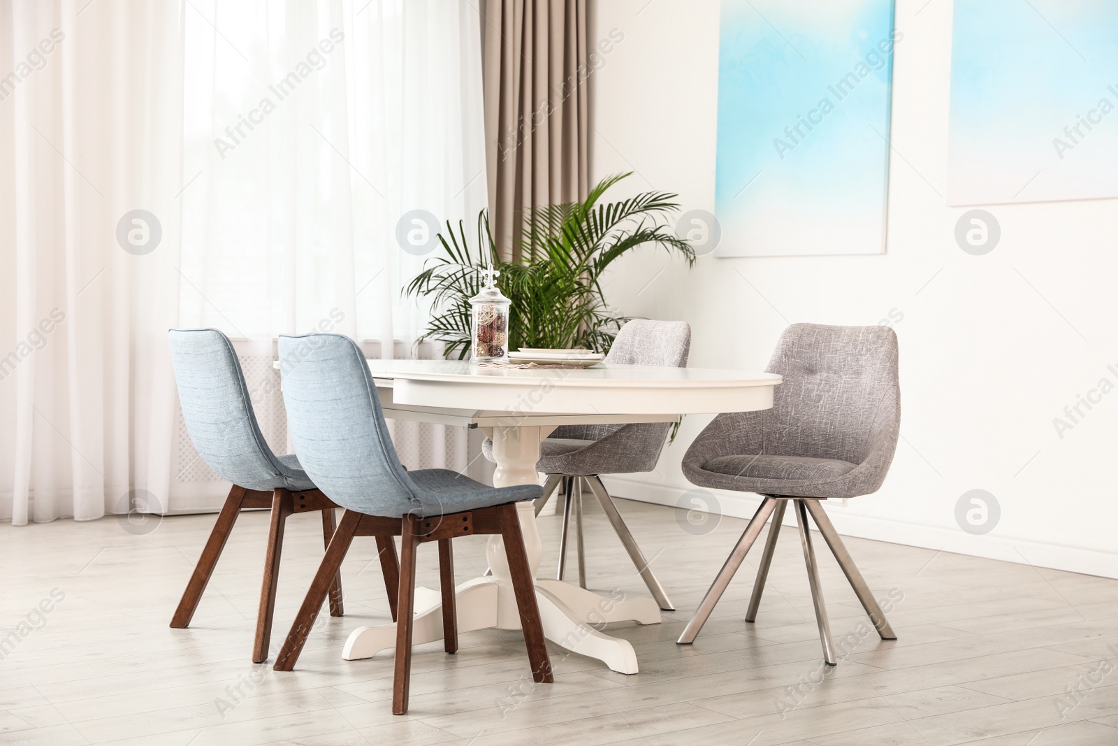 Photo of Stylish room interior with dining table and chairs