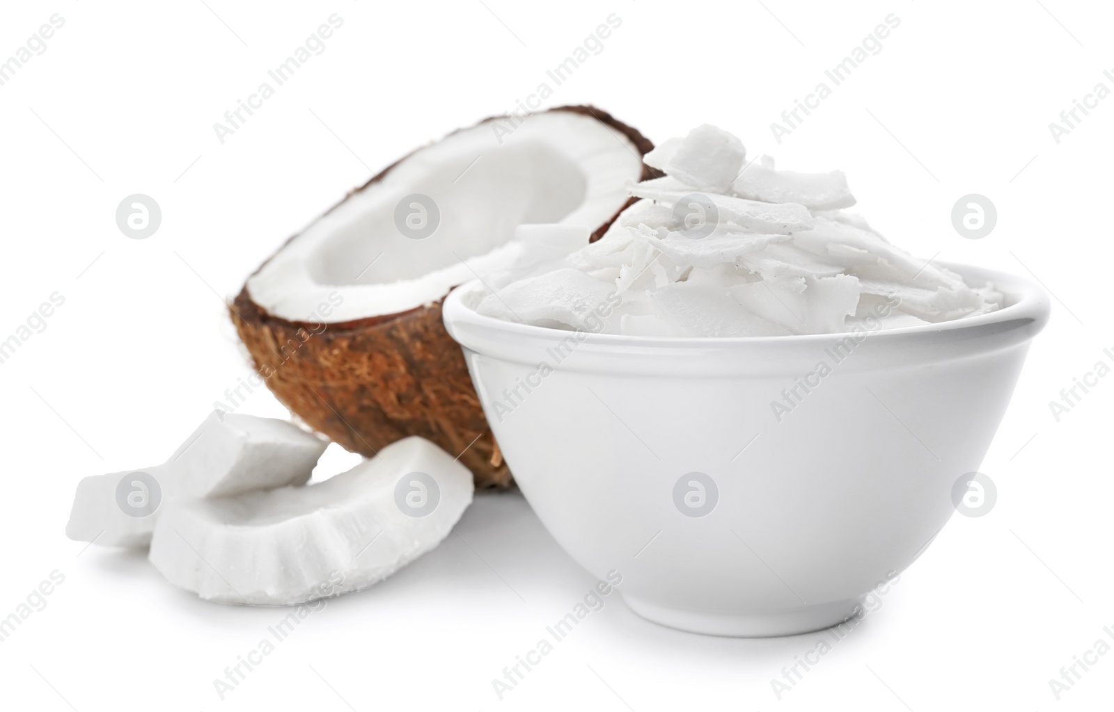 Photo of Fresh coconut flakes in bowl on white background