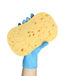 Cleaner in rubber glove holding new yellow sponge on white background, closeup