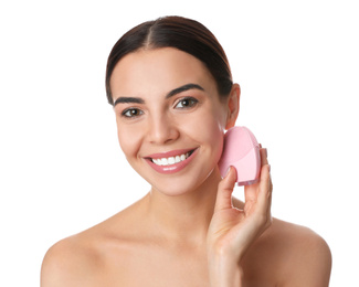 Photo of Young woman using facial cleansing brush on white background. Washing accessory