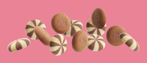 Set of different falling cookies on pink background. Banner design 