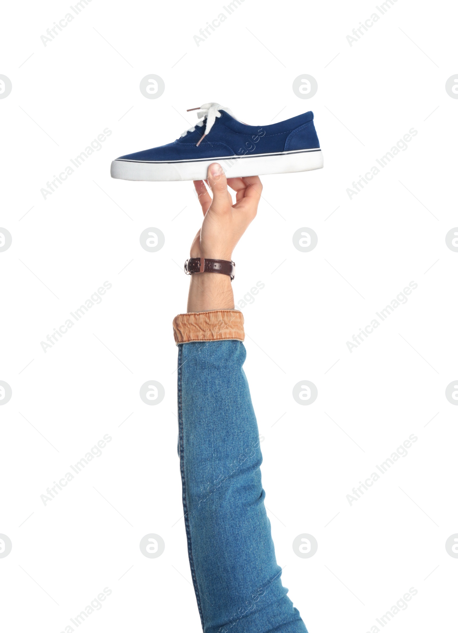 Photo of Young man holding comfortable shoe on white background, closeup