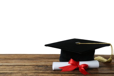 Photo of Graduation hat and diploma on wooden table against  white background, space for text