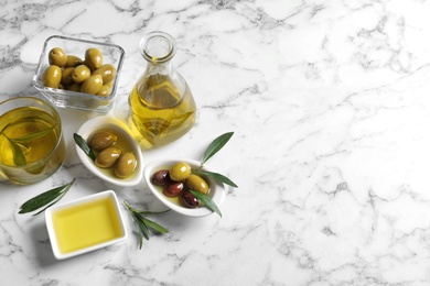 Composition with fresh olive oil on marble background