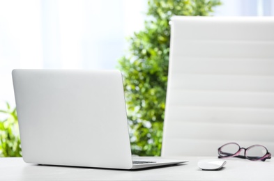 Photo of Laptop on desk in home office. Comfortable workplace