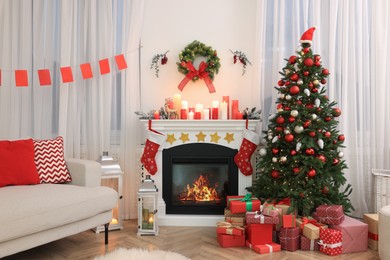 Festively decorated room with Christmas tree, gift boxes, fireplace and sofa. Interior design