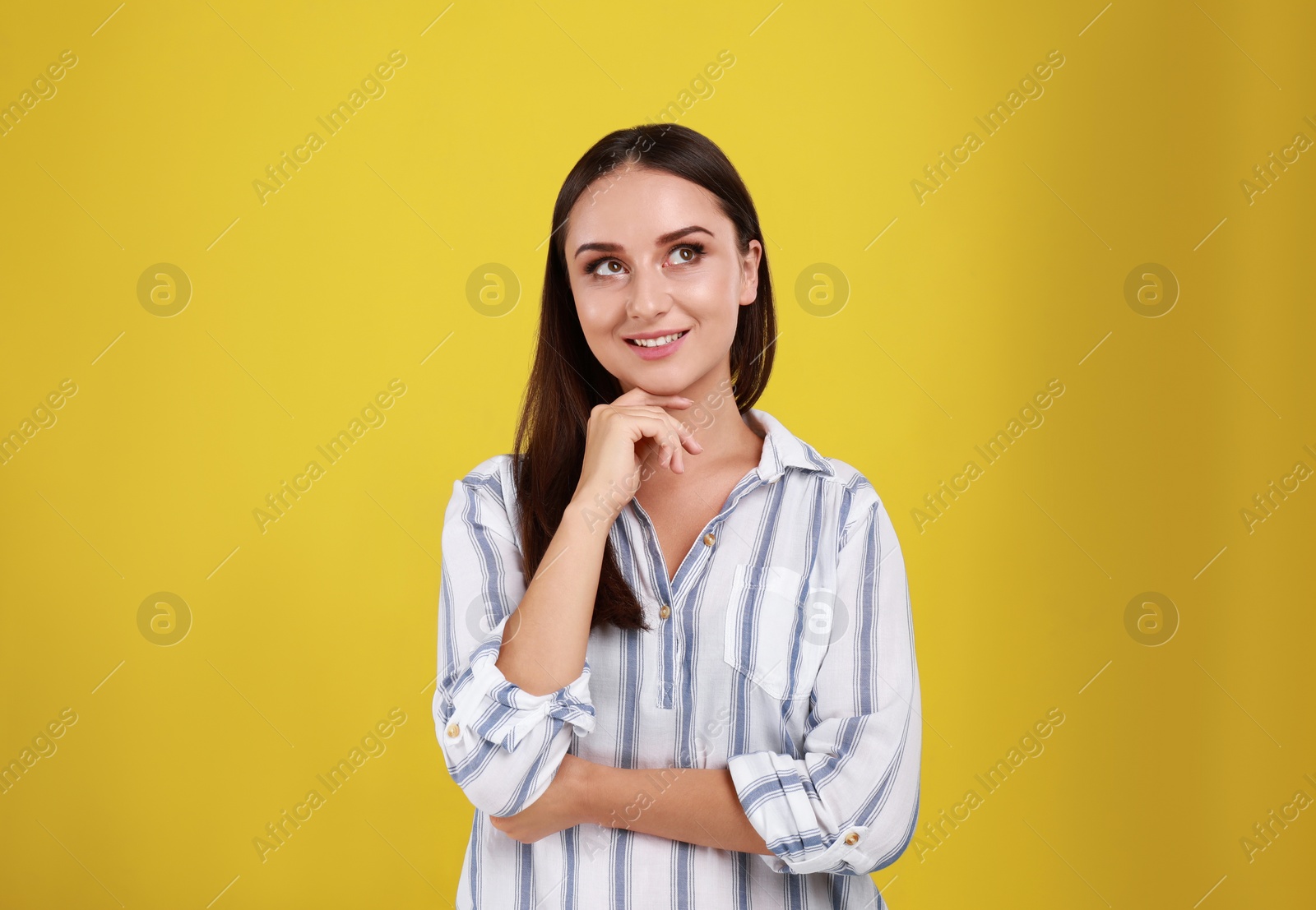 Photo of Beautiful young woman in casual outfit on yellow background