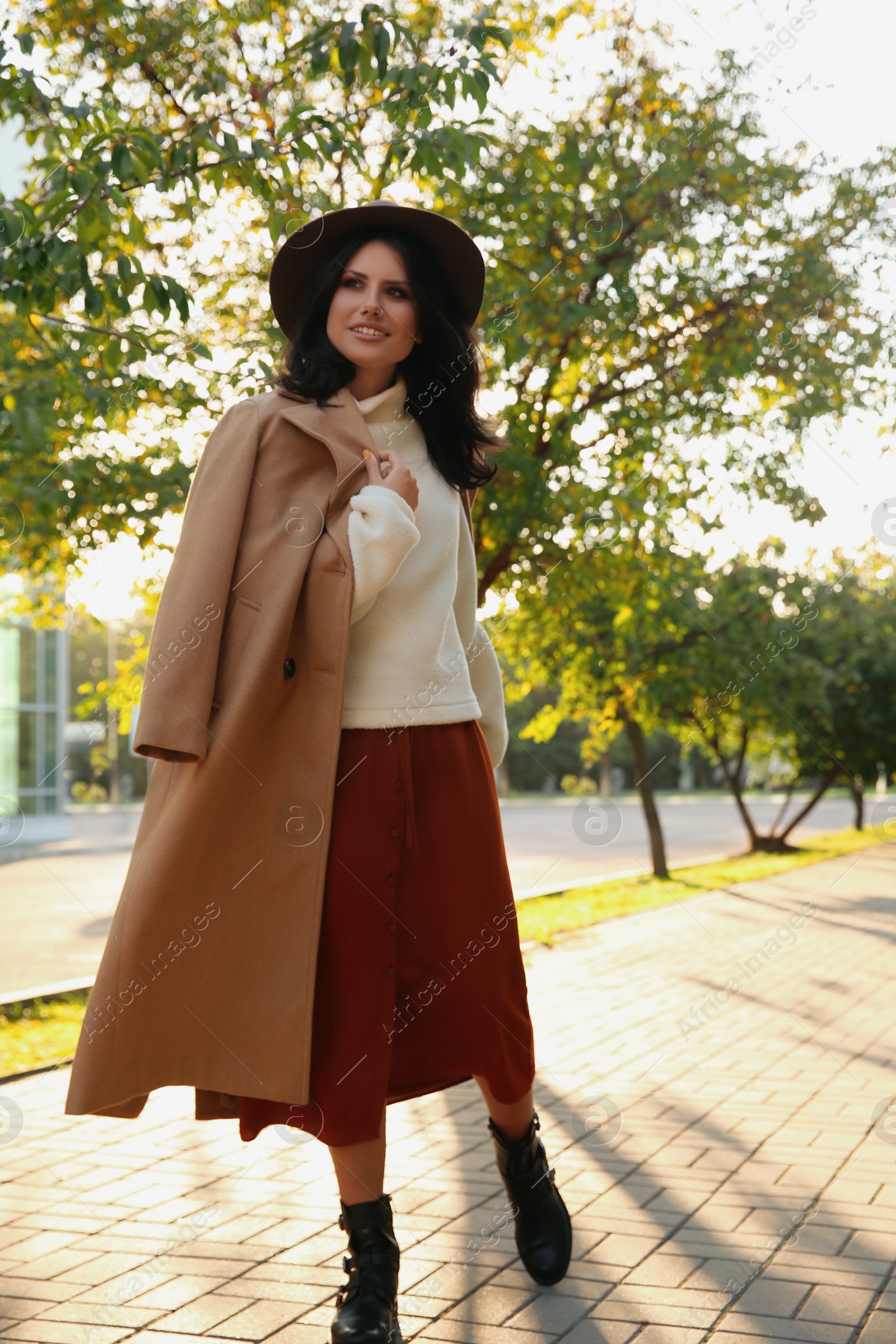 Photo of Beautiful young woman wearing stylish clothes in autumn park