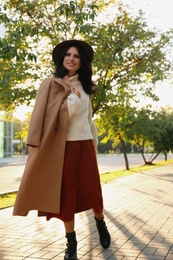 Beautiful young woman wearing stylish clothes in autumn park