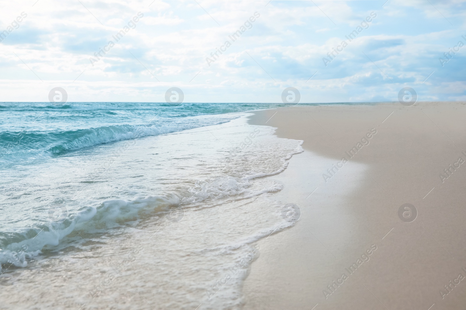 Photo of Sea waves rolling onto sandy tropical beach