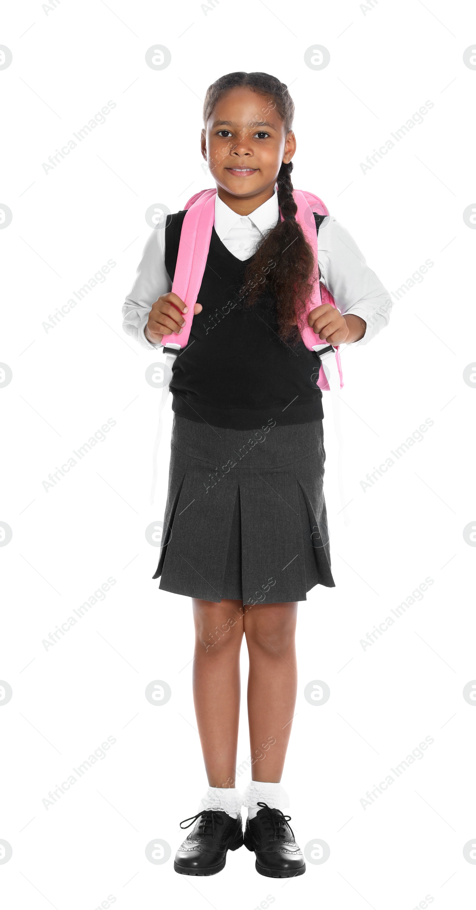 Photo of Happy African-American girl in school uniform on white background