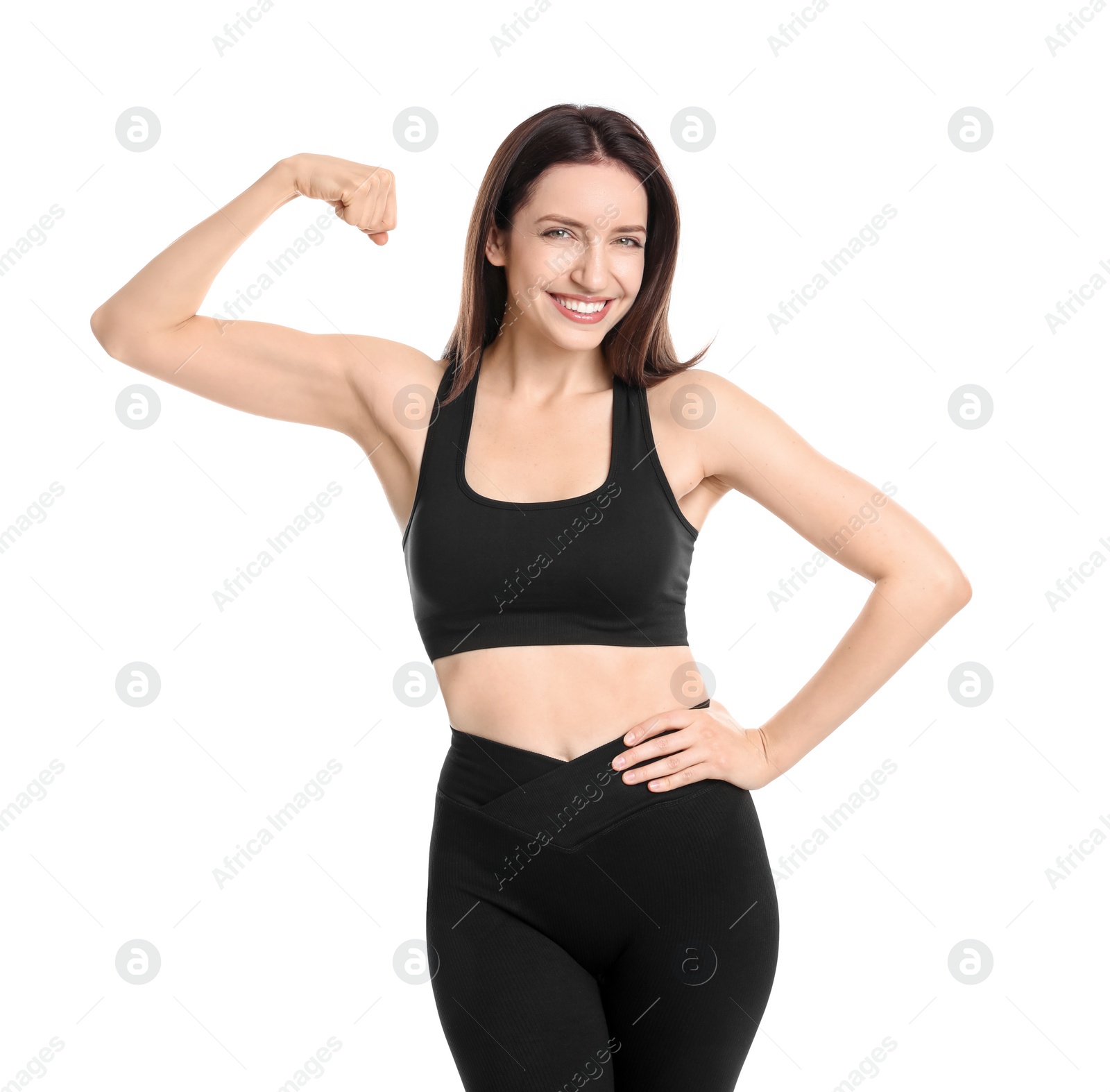 Photo of Happy young woman with slim body showing muscles on white background