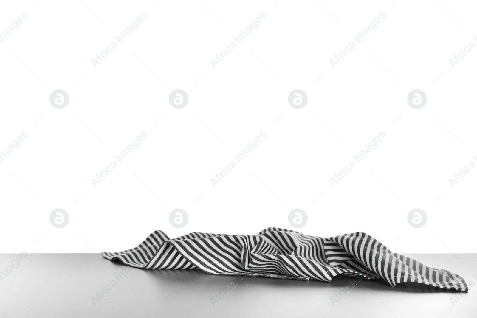 Photo of Crumpled napkin on table against white background