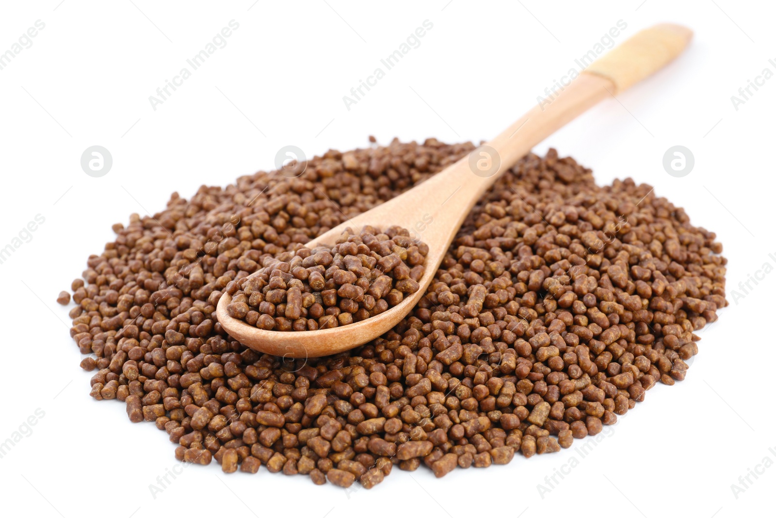 Photo of Wooden spoon and buckwheat tea granules on white background