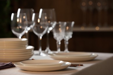 Clean dishware and glasses on table indoors