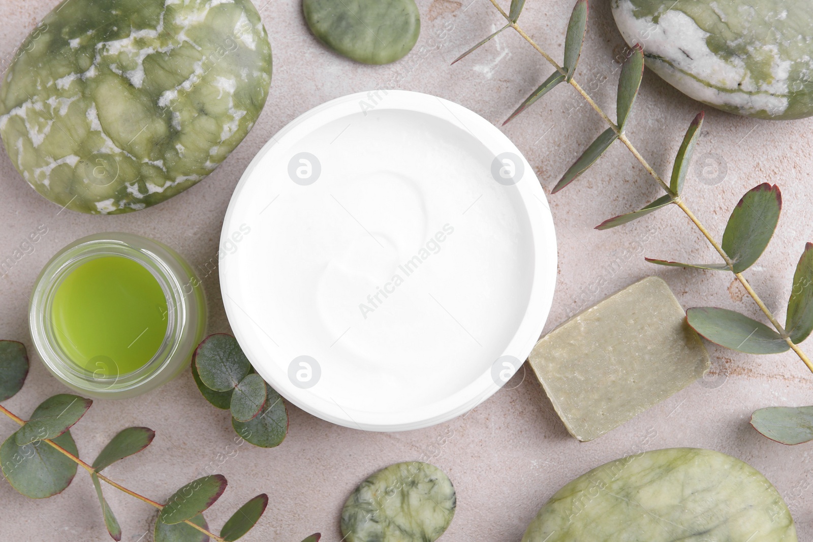 Photo of Flat lay composition with jars of cream on light textured table. Body care products