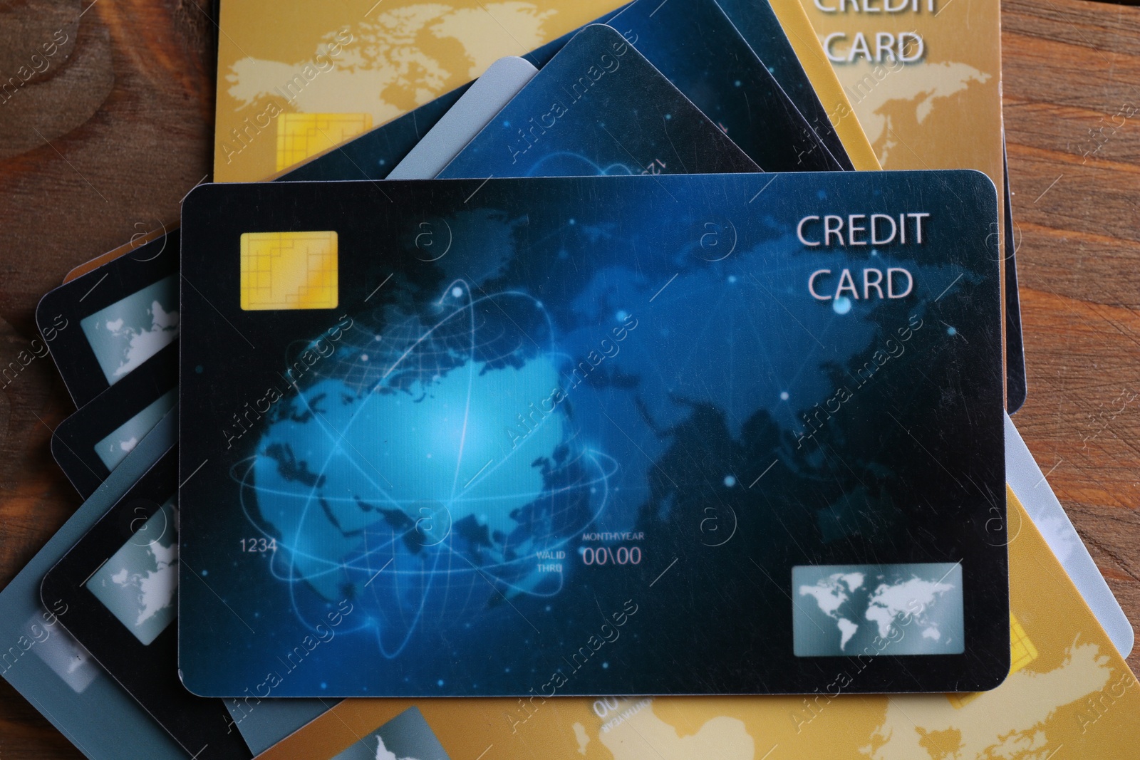 Photo of Many credit cards on wooden table, flat lay