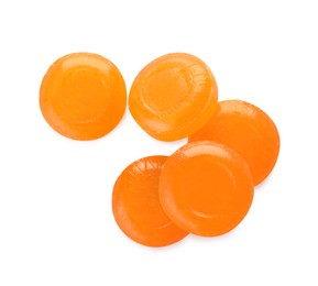 Photo of Many orange cough drops on white background, top view