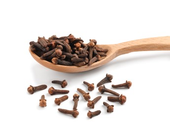 Photo of Aromatic dry cloves and wooden spoon on white background
