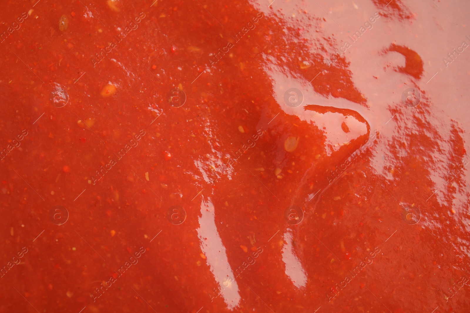 Photo of Fresh tasty tomato sauce as background, closeup