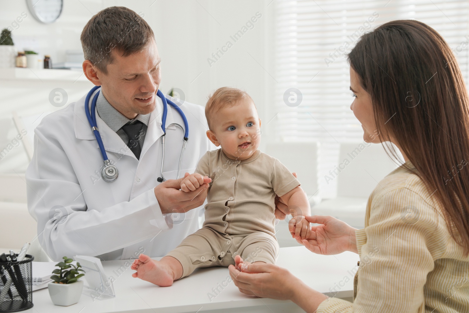 Photo of Mother with her cute baby visiting pediatrician in clinic