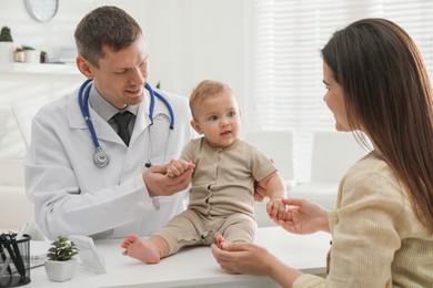 Photo of Mother with her cute baby visiting pediatrician in clinic