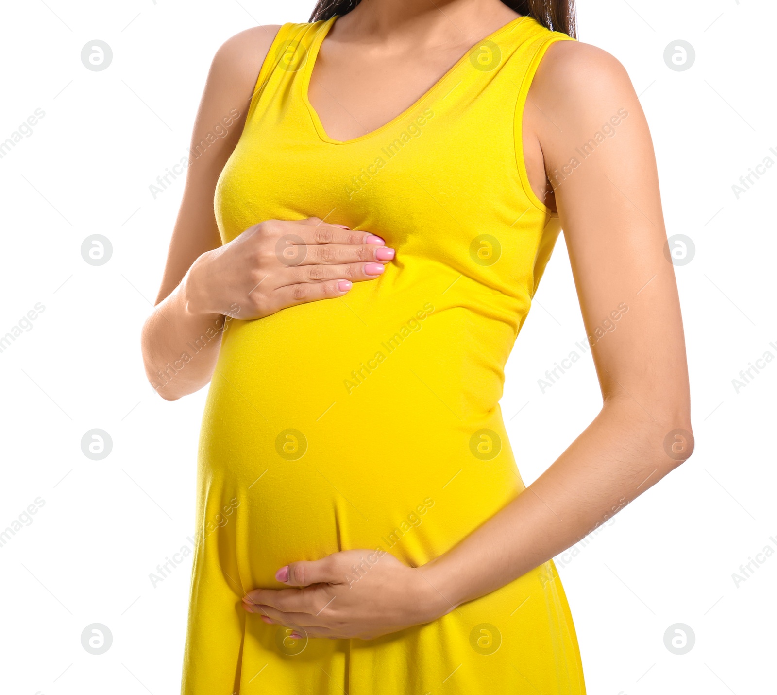 Photo of Young pregnant woman in casual clothes on white background