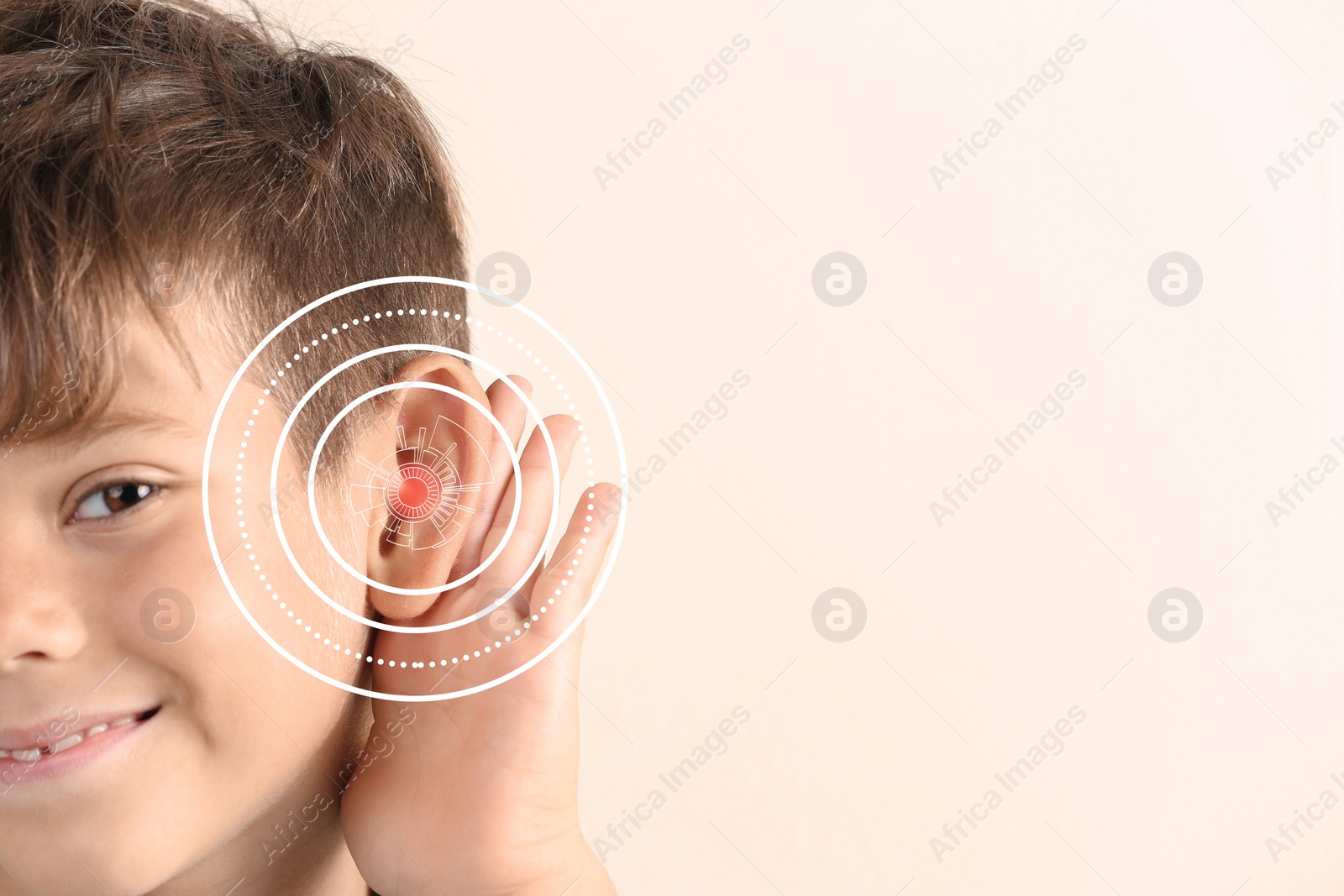 Image of Cute little boy with hearing problem on light background, closeup. Space for text