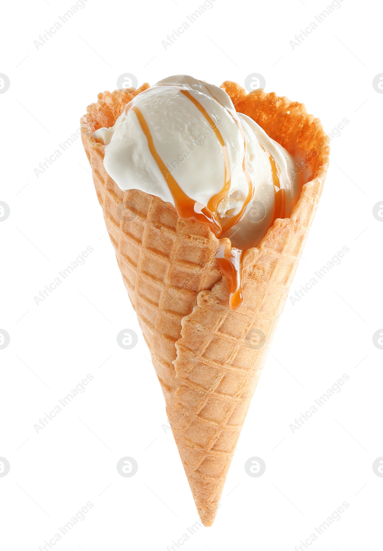 Photo of Delicious ice cream with caramel sauce in waffle cone on white background