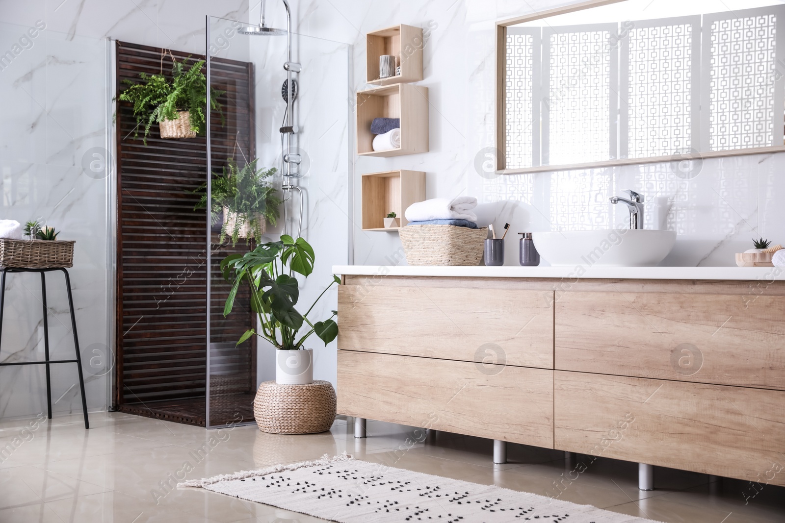 Photo of Bathroom interior with shower stall, counter and houseplants. Idea for design