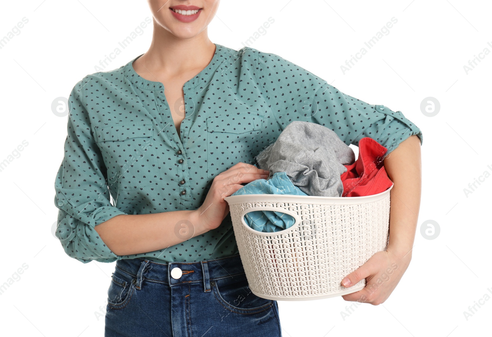 Photo of Happy young woman holding basket with laundry on white background