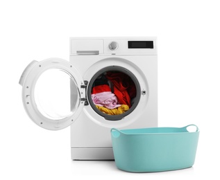 Modern washing machine with laundry and basket on white background