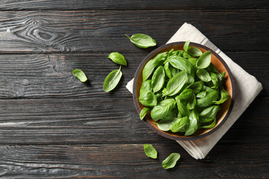 Photo of Fresh green basil on black wooden table, flat lay