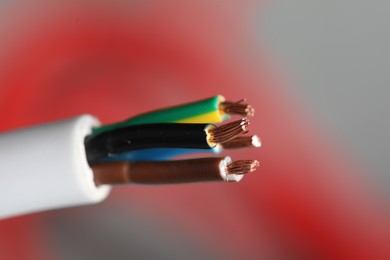 Photo of Colorful electrical wire on blurred background, closeup