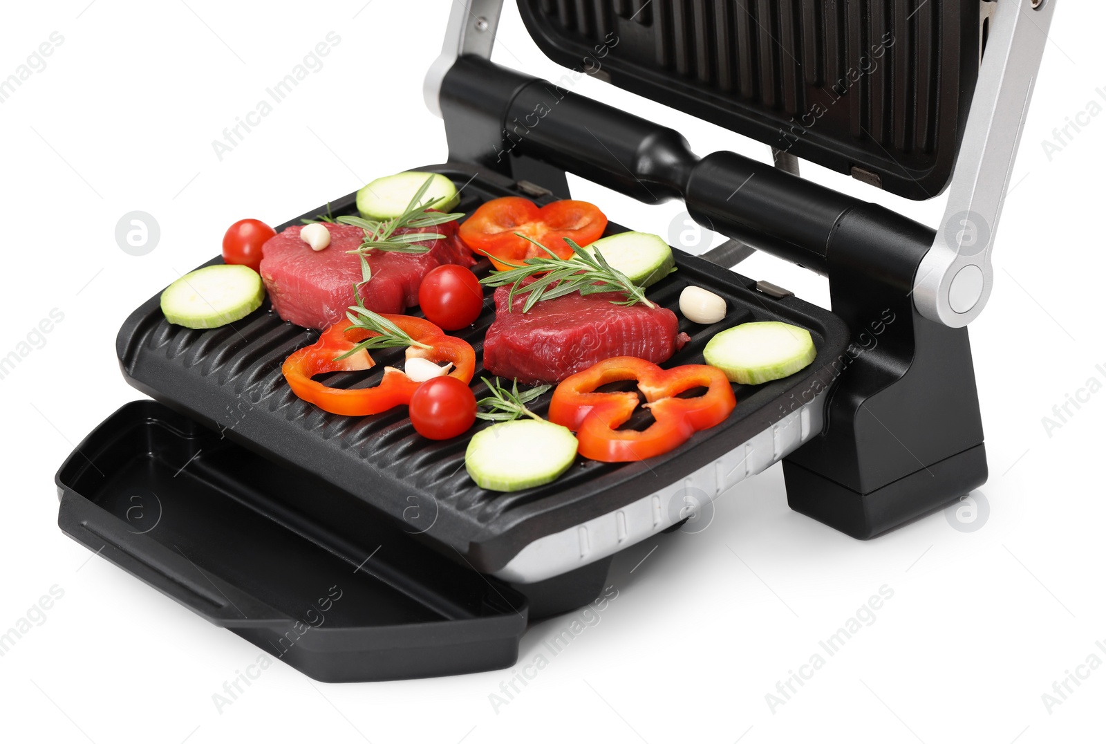 Photo of Electric grill with raw meat, rosemary and vegetables isolated on white