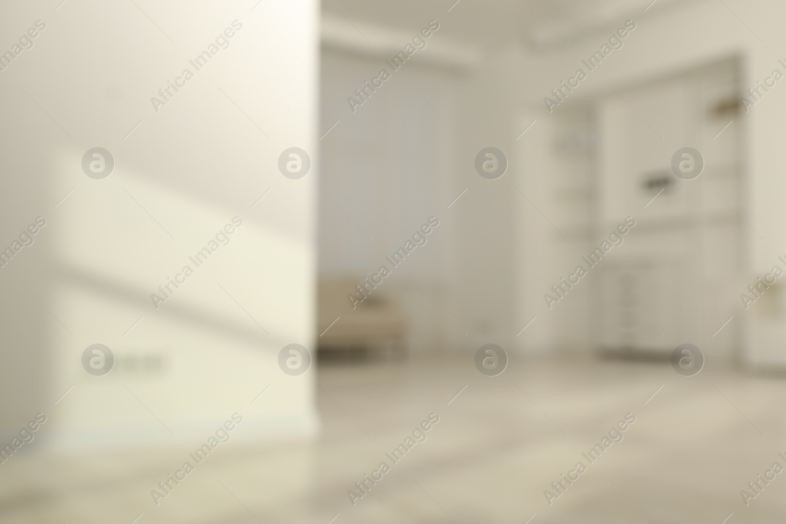 Photo of Blurred view of room with sofa and shadows on wall