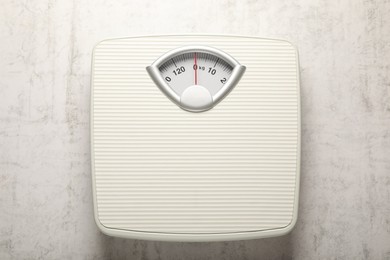 Photo of Weigh scales on white textured background, top view. Overweight concept