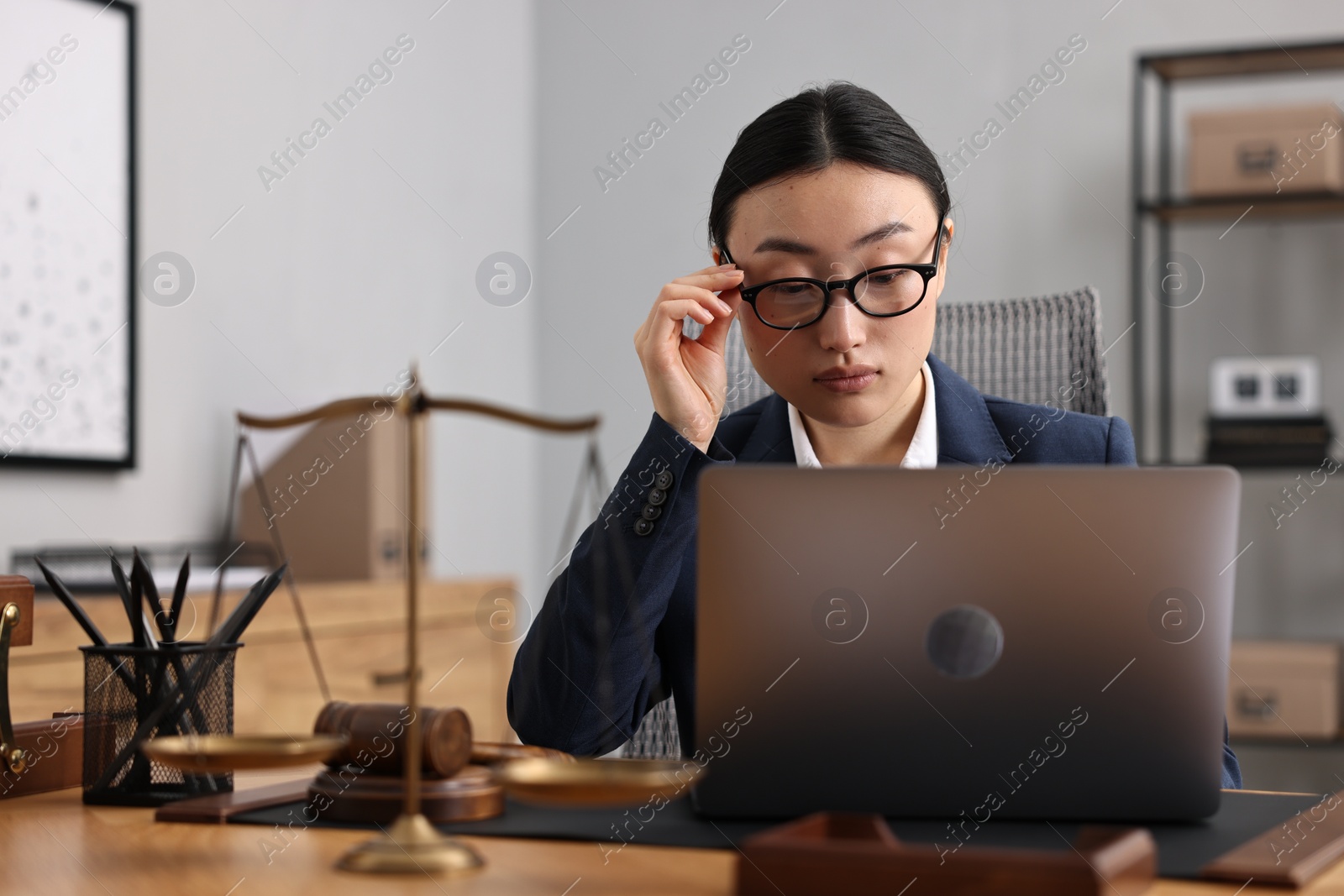 Photo of Notary working with laptop at table in office