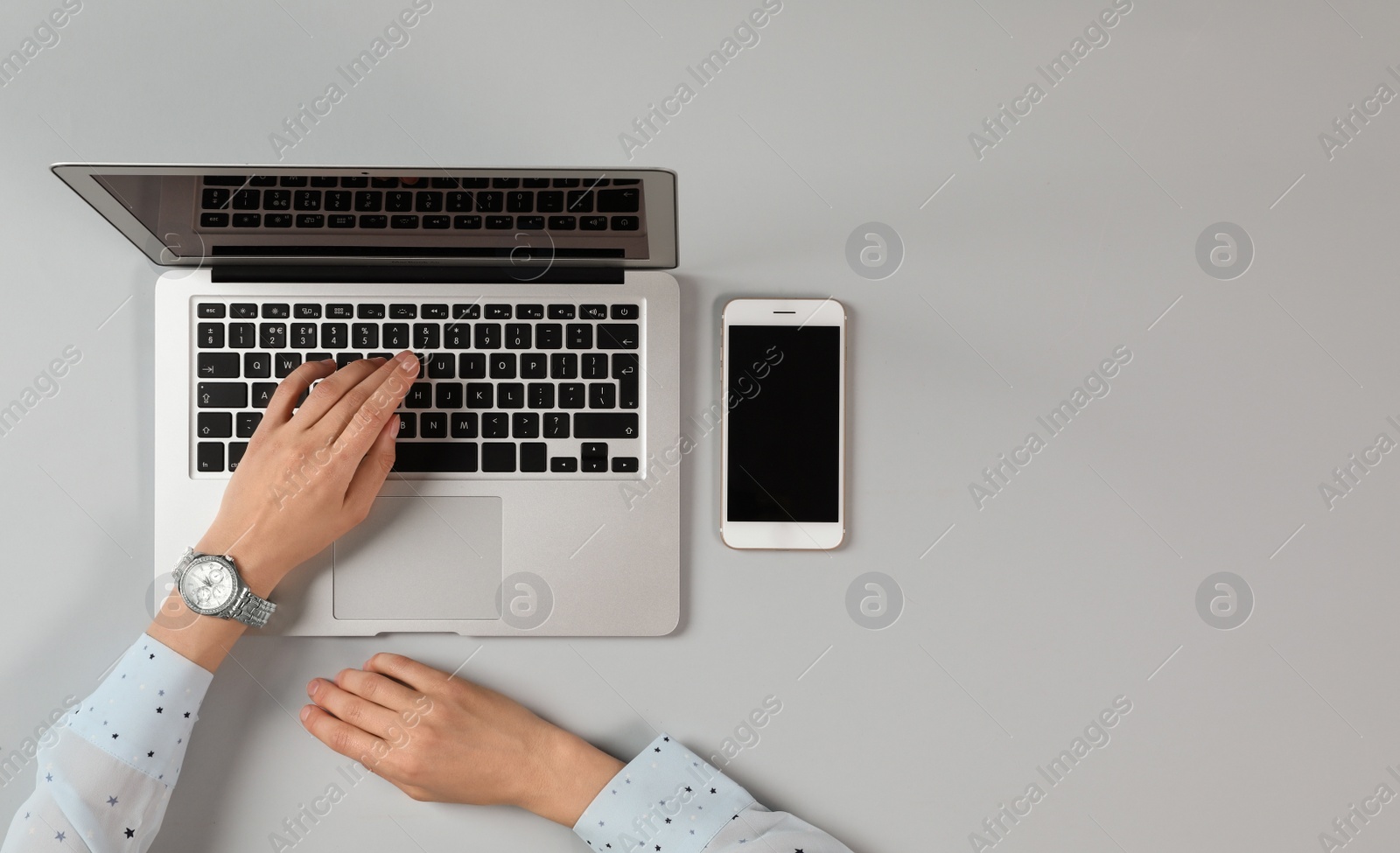 Photo of Woman using modern laptop at table, top view. Space for text