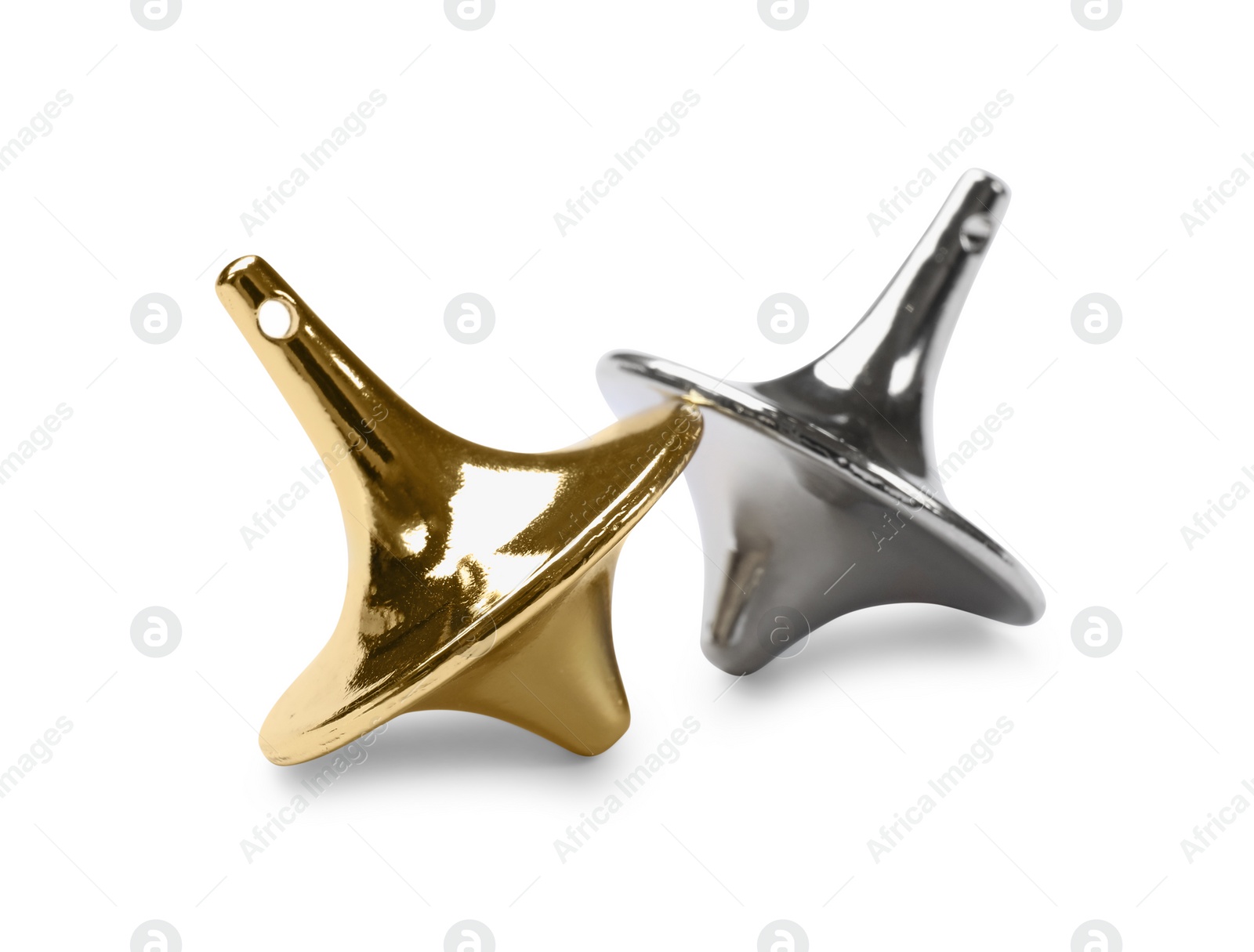 Photo of Golden and silver spinning tops on white background