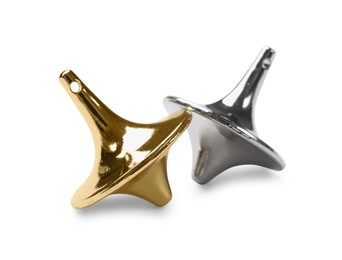 Photo of Golden and silver spinning tops on white background