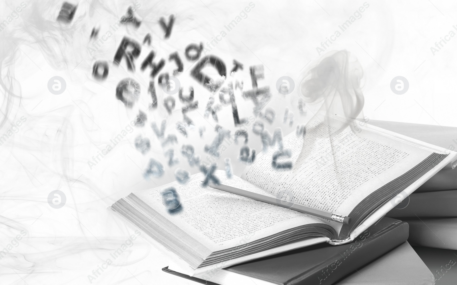 Image of Open book with flying letters on white background. Dyslexia concept