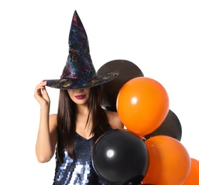 Photo of Beautiful woman wearing witch costume with balloons for Halloween party on white background