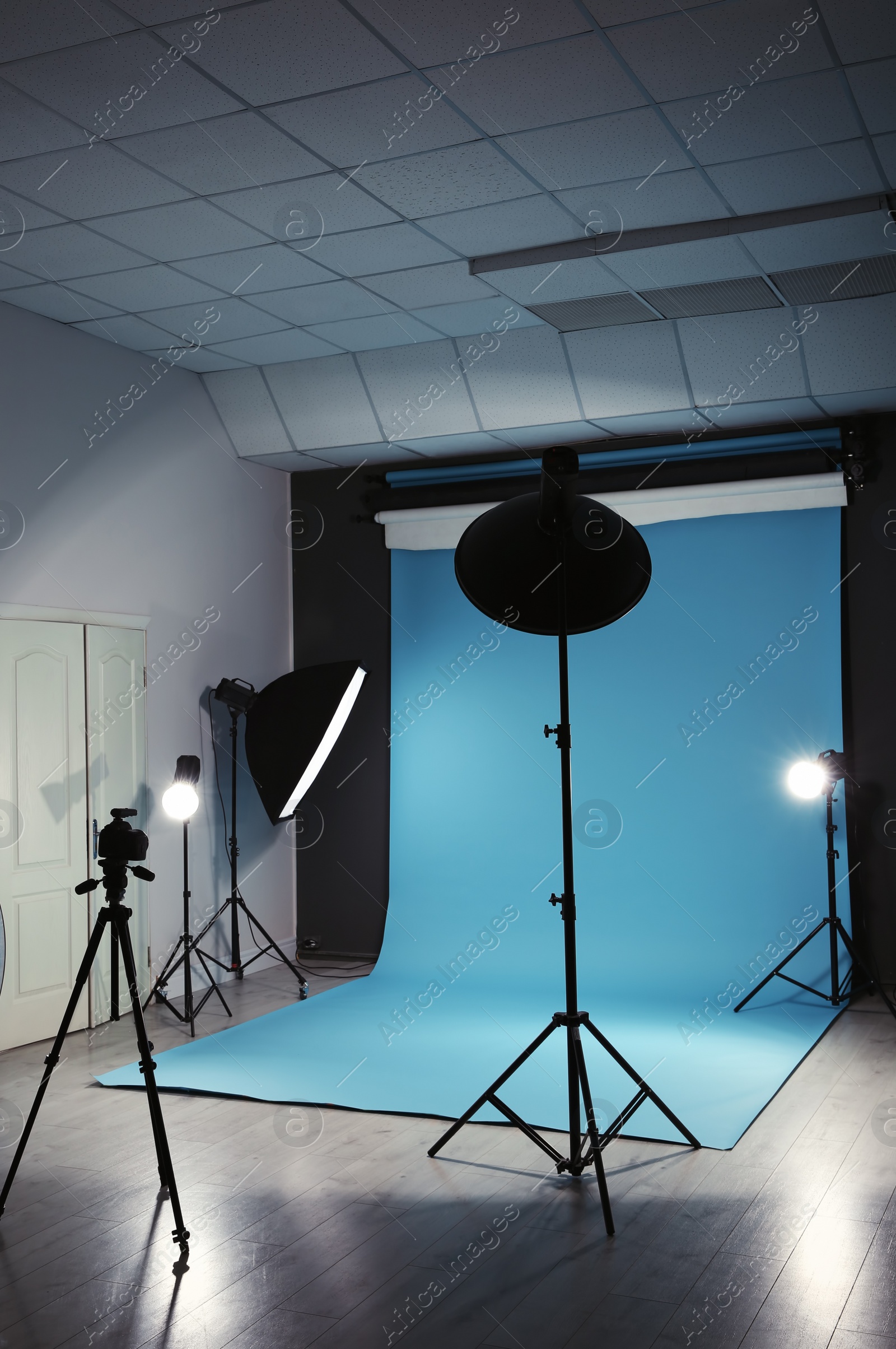 Photo of Modern photo studio interior with professional lighting equipment