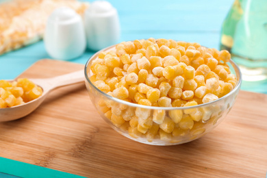 Frozen sweet corn on wooden board, closeup. Vegetable preservation