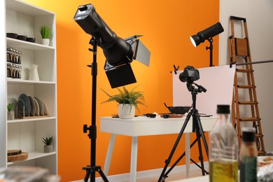 Photo of Professional equipment and composition with delicious meat medallion on white table in studio. Food photography