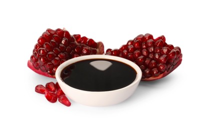 Photo of Bowl of pomegranate sauce and fresh ripe fruit on white background