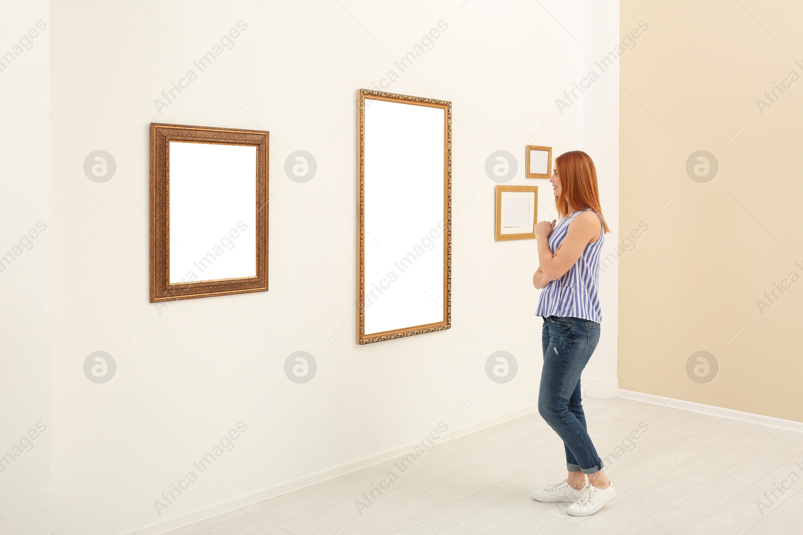 Photo of Woman viewing exposition in modern art gallery