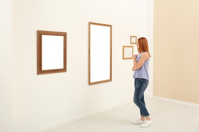 Woman viewing exposition in modern art gallery