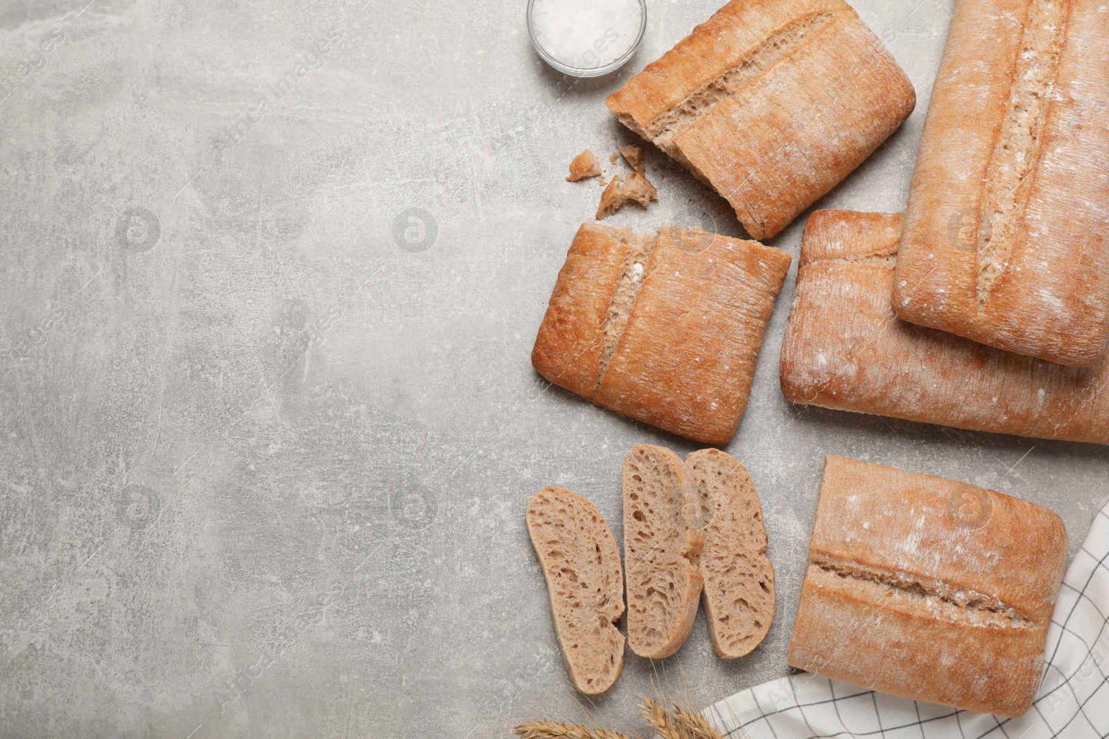 Photo of Fresh crispy ciabattas on grey table, flat lay. Space for text